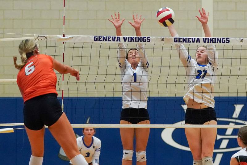 Geneva’s Alyssa Stevenson (1) and Molly Franz (27) defend the net against a kill attempt from Wheaton Warrenville South's Mackenzie Hartman (6) during a DuKane Conference match in Geneva on Tuesday, Sept. 16, 2025.