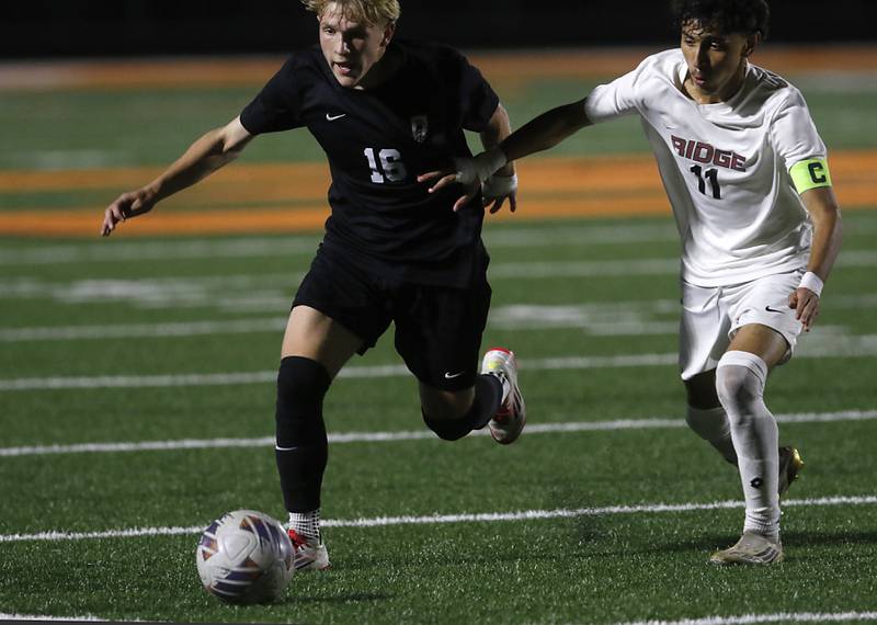 McHenry's Cody Bundy beats McHenry's Santiago Antonio to the ball during a Fox Valley Conference boys soccer match on Tuesday, Sept. 30, 2025, at McCracken Field in McHenry.