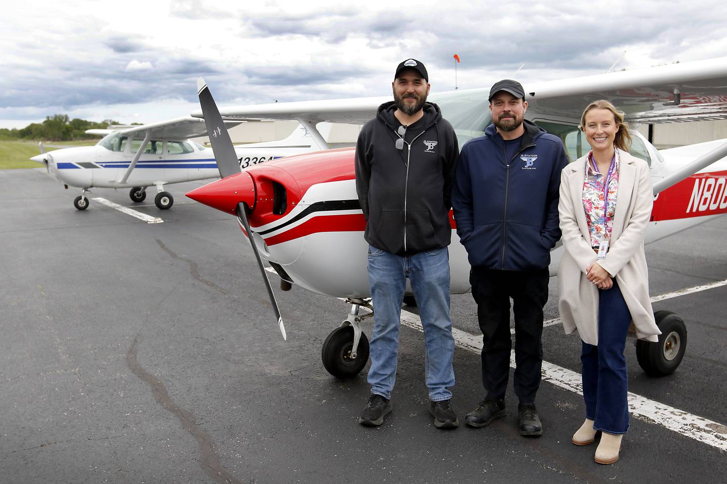 McHenry County College's Alex Benn (right) with JB Aviation owners Brian Spiro (left) and Justin Cleland (center) on Thursday, May 22, 2025, at Galt Airport in Wonder Lake. McHenry County College is partnering with JB Aviation for a new aeronautics class where students will learn to fly airplanes in a new certificate program.