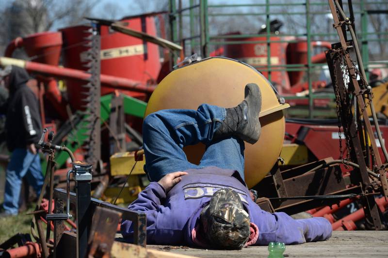 A man takes a nap on a trailer at the Hazelhurst Annual Spring Consignment Auction on Saturday, April 6, 2024. The annual event is held each year on a farm along Milledgeville Road, between Polo and Milledgeville.