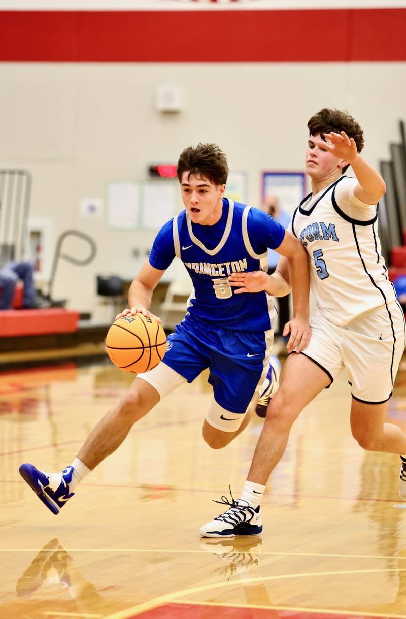 Princeton's Jack Oester drives on Bureau Valley's Logan Philhower in Saturday's Colmone Classic action at Hall High School. The Tigers won 86-83 in double OT.