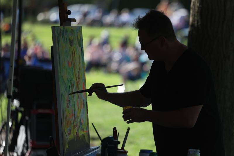 Lewis Achenbach does paint at the park for the evening concert at Preservation Park. The Upper Bluff Historic District hosted Porch & Park Music Fest featuring a variety of musical artist at five different locations. Saturday, July 30, 2022 in Joliet.