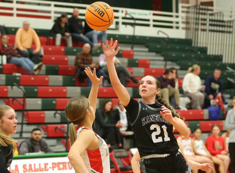 Kaneland's Kyra Lilly lets go of a shot over L-P's Phoebe Shetterly on Wednesday, Jan. 15, 2025 in Sellett Gymnasium at L-P High School.