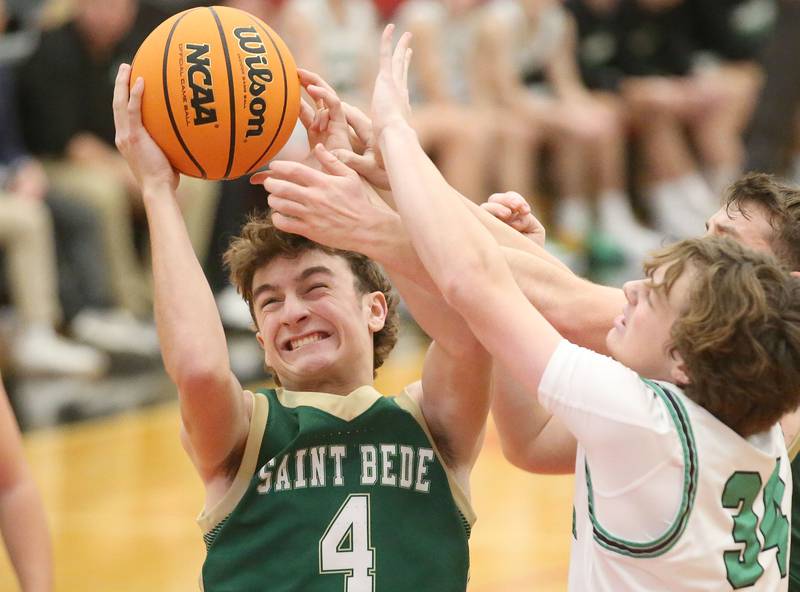 St. Bede's Gino Ferrari grabs a rebound over Eureka's Isaac Schaefer during the 50th annual Colmone Classic on Monday, Dec. 9, 2024 at Hall High School.