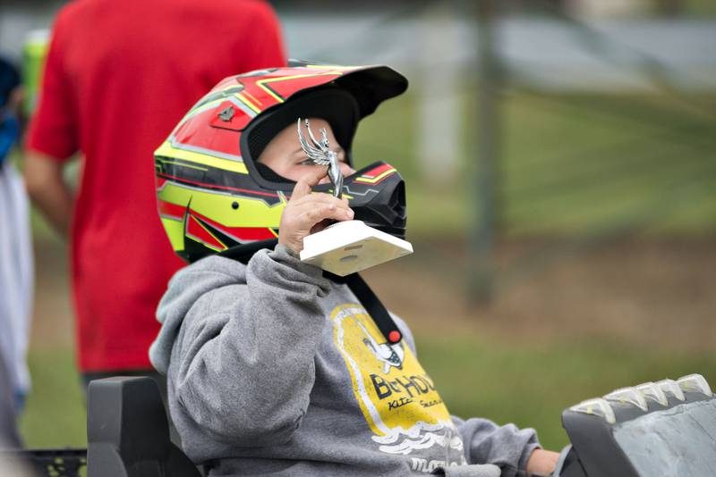 Ryan Jomant, 6, of Morrison hoists his trophy after the kid's demo derby Saturday at Peat Monster in Morrison.