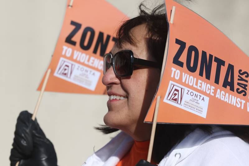 Yolanda Reyes, of Joliet, marches around the old court house during a rally for Zonta Says No To Violence Against Women Tuesday in Joliet.