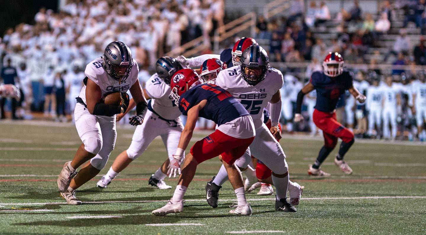 Oswego East's Oshobi Odior (23) carries the ball against West Aurora during a high school football game at West Aurora High School in Aurora on Friday, Sep 24, 2021.