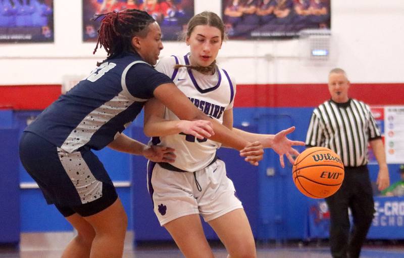 Hampshire’s Aubrey Fudala, right, drives as South Elgin’s Liv Miller defends in varsity girls basketball Komaromy Classic tournament  action on Monday, Dec. 29, 2025, at Dundee-Crown High School in Carpentersville.