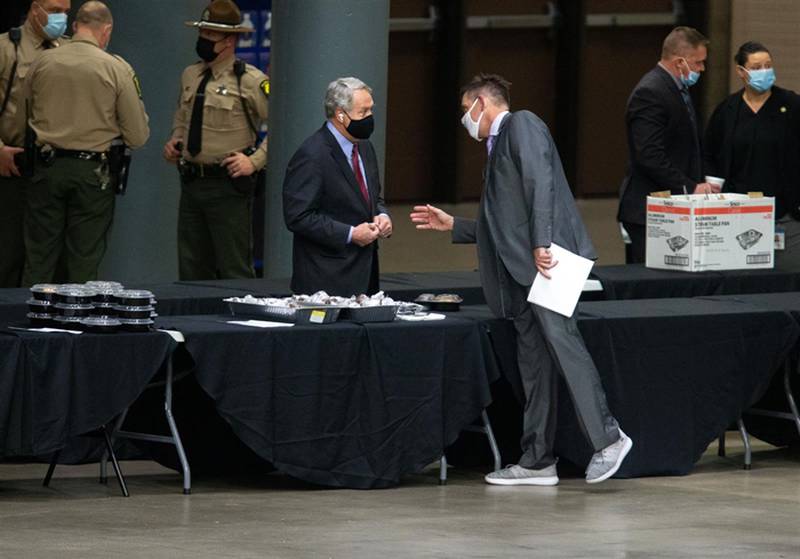 State Reps. Jay Hoffman (left), D-Swansea, and Tim Butler, R-Springfield, talk during the lame-duck session for the Illinois House of Representatives on Jan. 12, 2021, at the Bank of Springfield Center in Springfield. During that session, the House met at the convention center, several blocks from the Statehouse, while the Senate continued to meet in the Capitol under strict testing, masking and social distancing protocols. This year's session was originally scheduled to start this week with three meeting days – Tuesday, Wednesday and Thursday. But leaders announced last week that they will meet only on Wednesday this week and likely will cancel all in-person meetings the following week, Jan. 11-13.