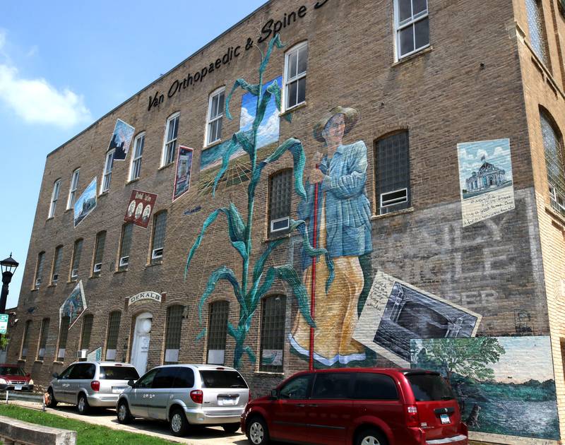The mural titled “Its Merits Recommend It...” by artist Olivia Gude Tuesday, July 22, 2025, graces the side of the building at the corner of Lincoln Highway and First Street in DeKalb.