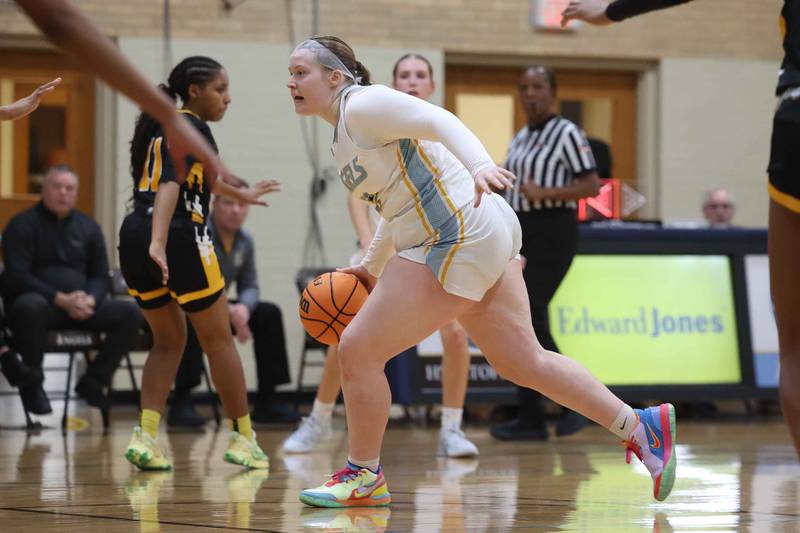 Joliet Catholic’s Emma Birsa looks for a play against Marian Catholic on Monday, Dec. 9, 2024 in Joliet.