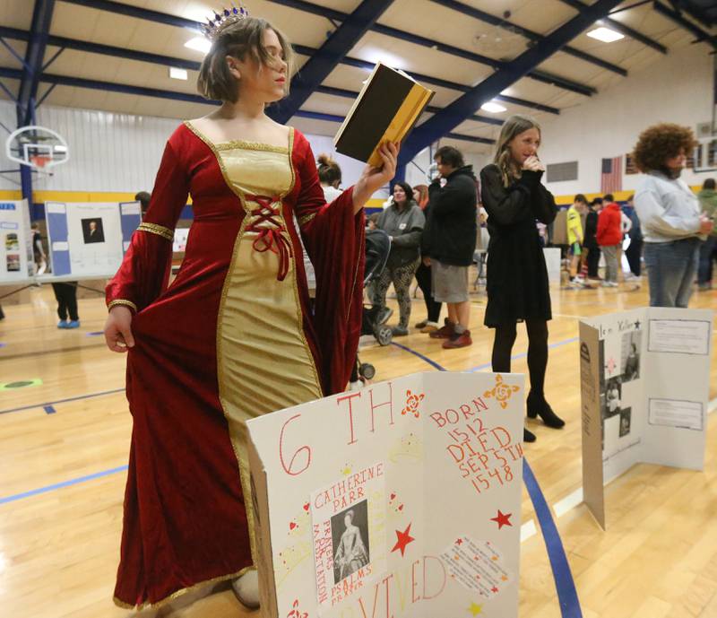 Allison Anderson poses as Catherine Parr during the live Wax Museum on Thursday, Feb. 27, 2025 at Logan Jr. High School in Princeton. Students made poster boards and dressed like their featured character at the event.