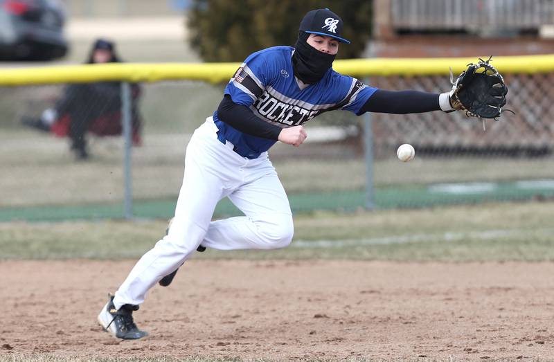 Sycamore's Collin Severson dives back safely to first as Burlington Central's AJ Payton takes the throw during their game Tuesday, March 21, 2023, at Sycamore Community Park.