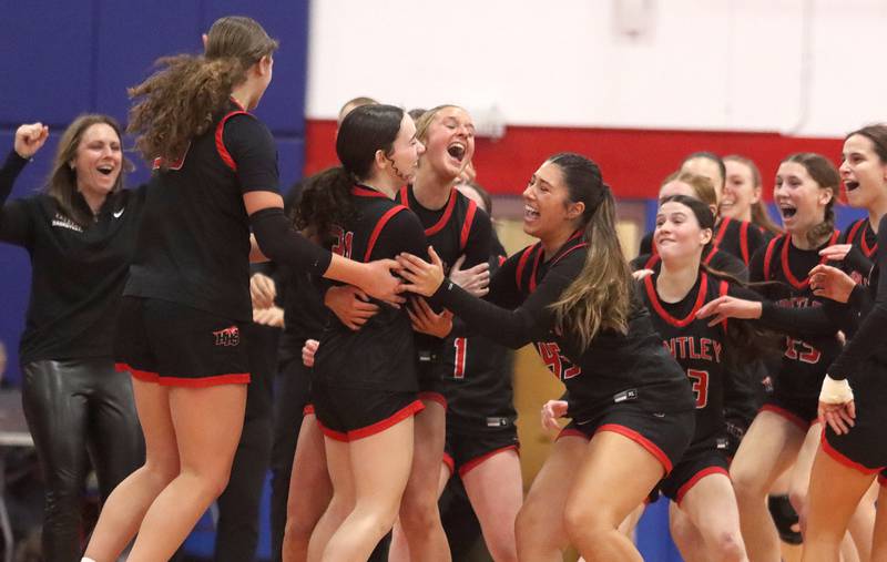 Huntley’s Red Raiders rejoice as Luca Garlin drains a half-court shot to conclude the first quarter against Maine South in Komaromy Holiday Classic varsity girls basketball championship game action on Monday, Dec. 30, 2024, at Dundee-Crown High School in Carpentersville.