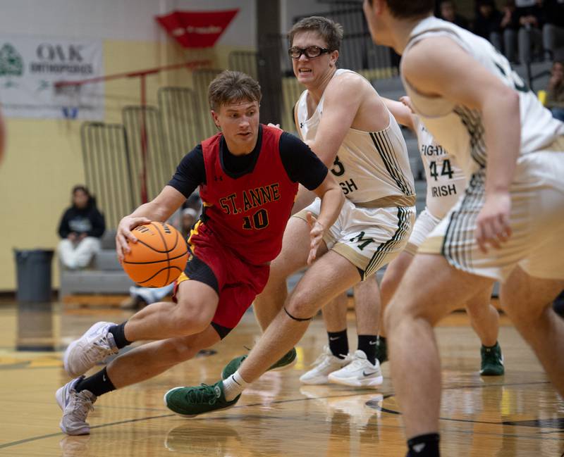 St. Anne's Grant Pomaranski, left, makes a break toward the net past Bishop McNamara's Callaghan O'Connor in a game on Wednesday, November 26, 2025.