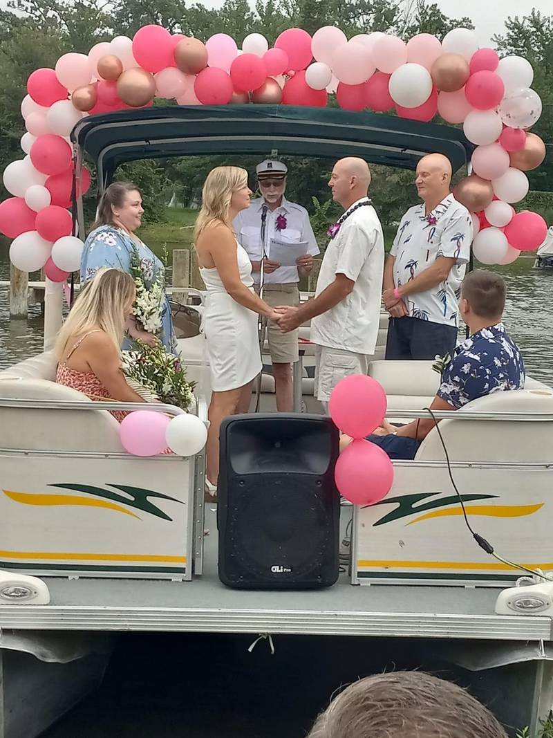 Sharon Kucharski and Mike Ginn married on a pontoon in Antioch on Sept. 4, 2022. Kucharski, a nurse, aided a woman experiencing low blood sugar on their honeymoon flight to Hawaii.