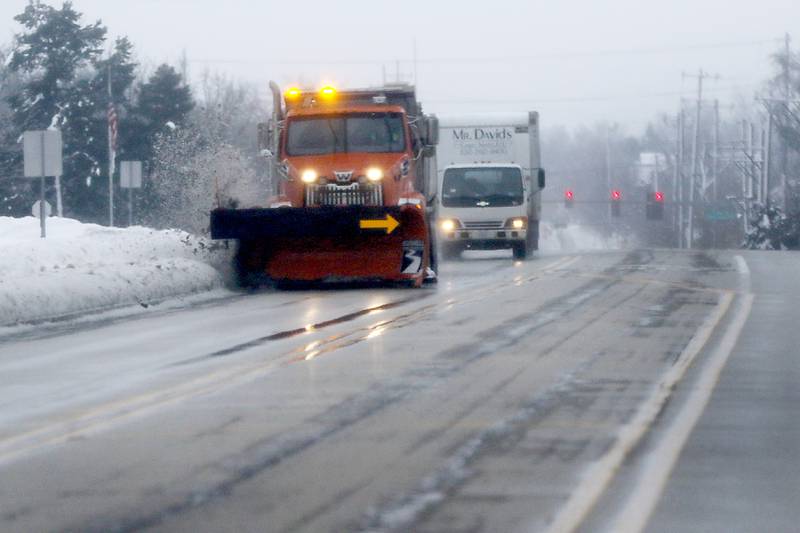 A snow plow removes slush from Walkup Avenue in Crystal Lake on Tuesday, Jan. 23, 2024. Residents throughout northern Illinois woke up to icy and slippery roads.