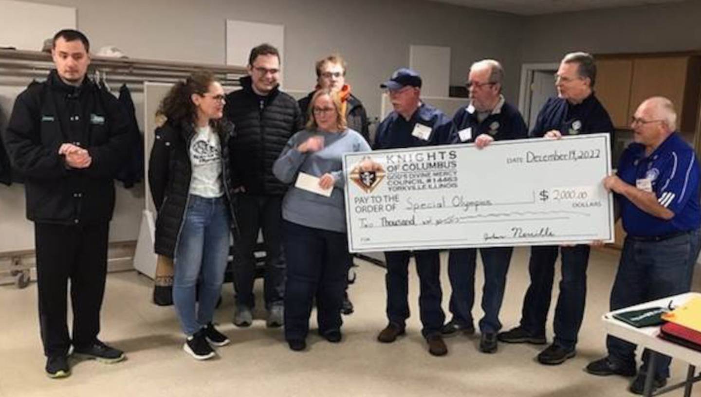 Pictured are Kendall County Special Olympics President Lori Kuehn and VP Lisa Hartman receiving the check.  Knights pictured from left are Grand Knight John Neville, Deputy Grand Knight Jim Zbella, ID Drive Chairman Michael Gach and Financial Secretary Dan Wiest.  Also pictured are Olympians Jeremy, Zach and Jack.