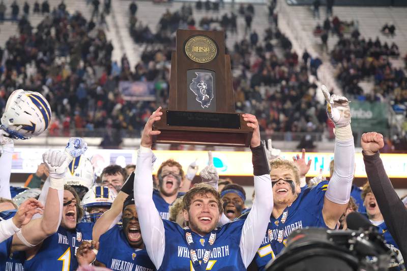 Wheaton Norths Mark Forcucci holds up the championship trophy after a 35-6 win over St. Rita in the Class 7A state championship at NIU Huskie Stadium. Saturday, Nov. 27, 2021 in Dekalb.