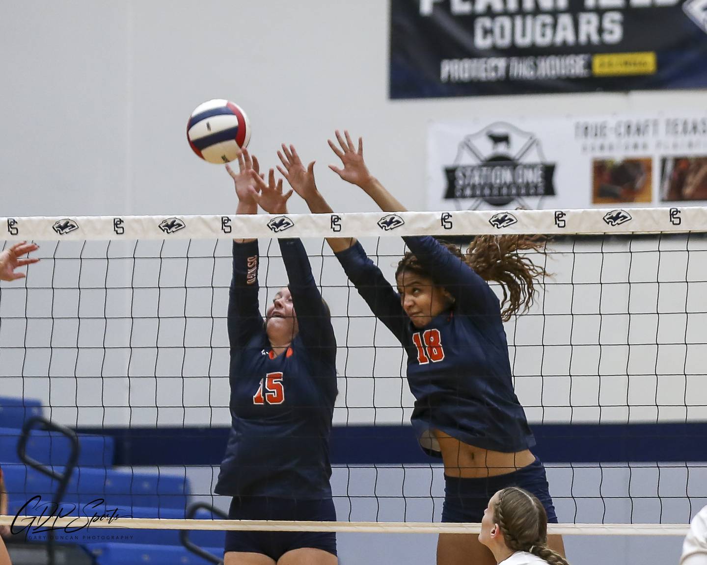 Oswego's Maya Norlin (18) and Kimberly Reichard (15) converge for a block attempt during Class 4A Regional Final volleyball match between Neuqua Valley at Oswego. Oct 30, 2025 in Plainfield.