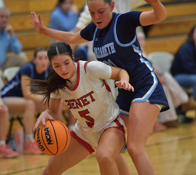 Benet’s Ava Thomas (5) drives as Nazareth’s Lyla Shelton  defends during a game on January 28, 2026 at Benet Academy in Lisle.