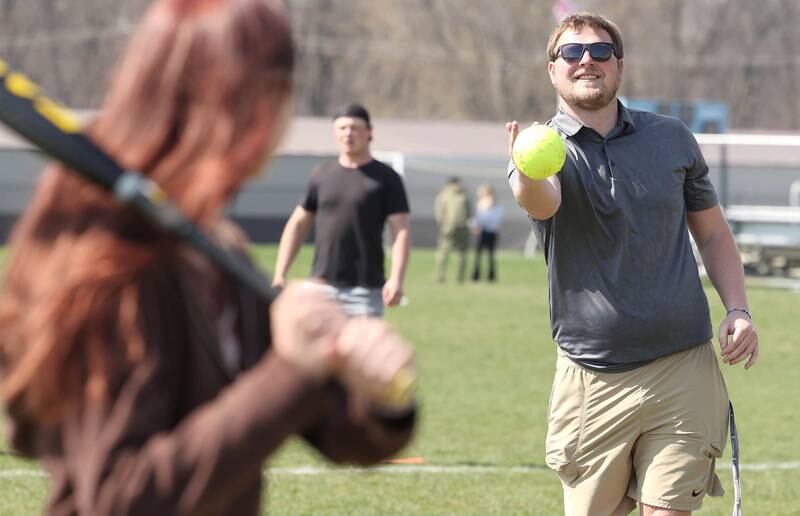 Griffin McNeal, Genoa-Kingston High School physical education teacher, pitches to students in his class Thursday, April 13, 2023, as they get outside to play some softball.