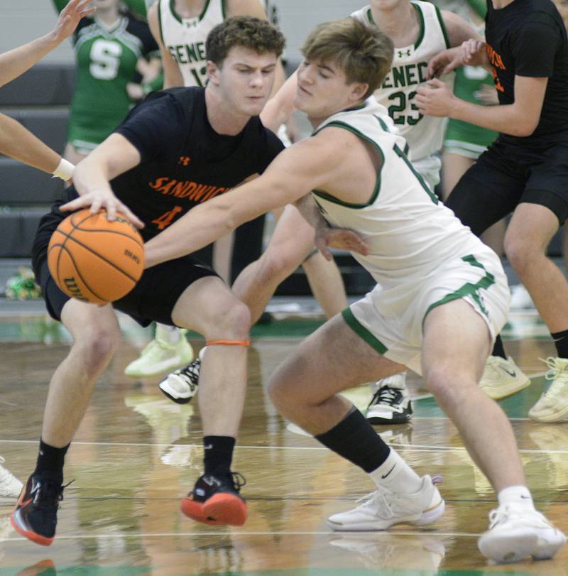 Seneca’s Cam Shriey knocks the ball away from Sandwich’s Griffin Somolock in the 2nd period Saturday during the MLK Shootout at Seneca.