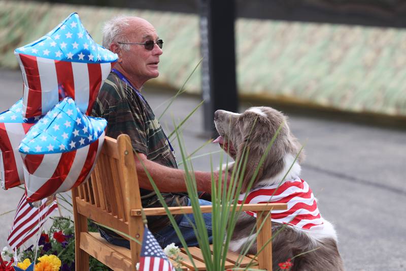 Andy Coning, an Army veteran who served in Vietnam sits with Hildy, a Newfoundland therapy dog, at the Vietnam Moving Wall on Saturday, July 1st, 2023, in Manhattan.