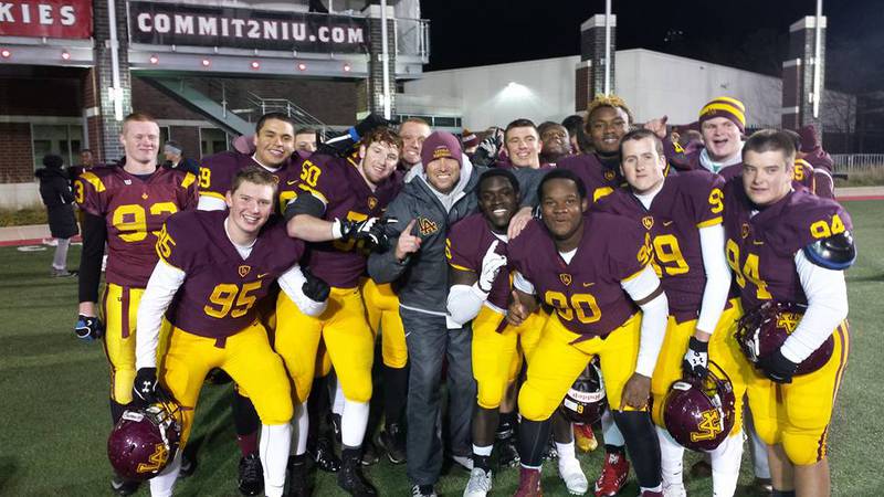 Loyola's Beau Desherow (center) celebrates with the Loyola Academy defensive line after Loyola defeated Marist 41-0 to clinch the 2015 IHSA Class 8A state championship, the second in school history. At the time, Desherow served as varsity defensive line coach. Photo provided by Loyola Academy