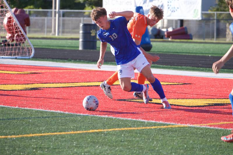 St. Charles North's Oliver Longosz looks to gain control of the ball against St. Charles East on Thursday, Sept. 25, 2025 in Batavia.