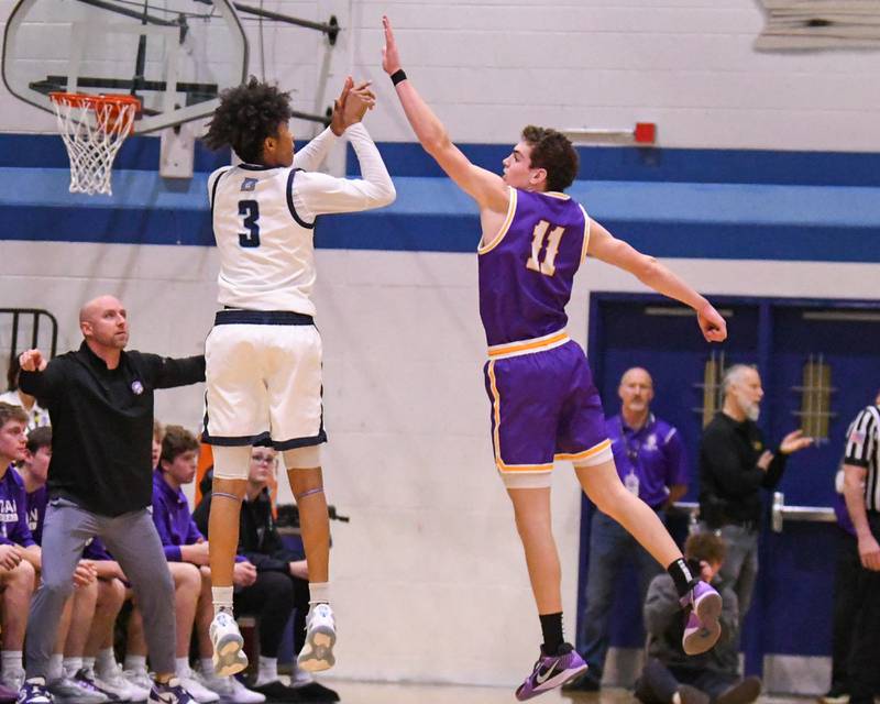 Downers Grove South's Adam Flowers (3) takes a shot while being defended by Downers Grove North's Jack Crowley (11) during the game on Saturday Dec. 21, 2024, held at Downers Grove South High School.