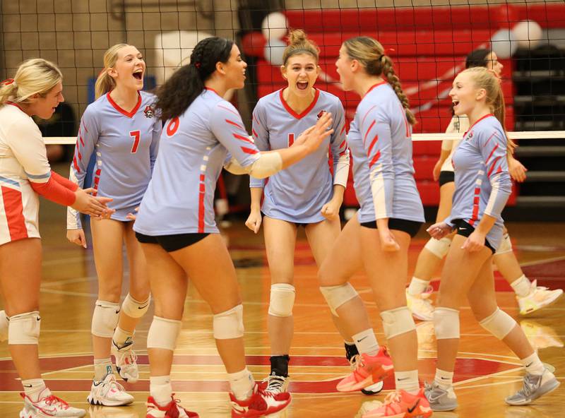 Members of the Ottawa volleyball team react after scoring a point against Sycamore on Thursday, Oct. 12, 2023 at Kingman Gym.