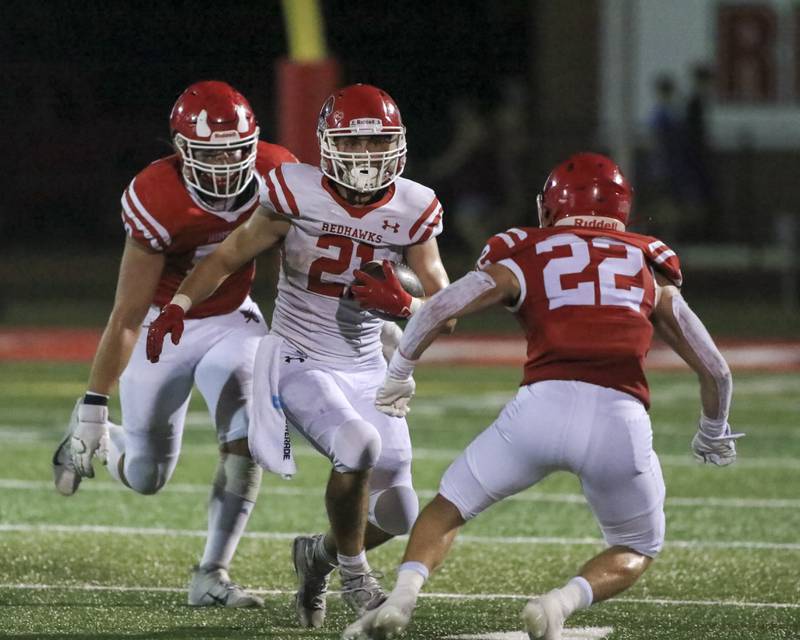 Naperville Central's Tyler Dodd eludes the Hinsdale Central defense during football game between Hinsdale Central vs Naperville Central.  August 27, 2021.