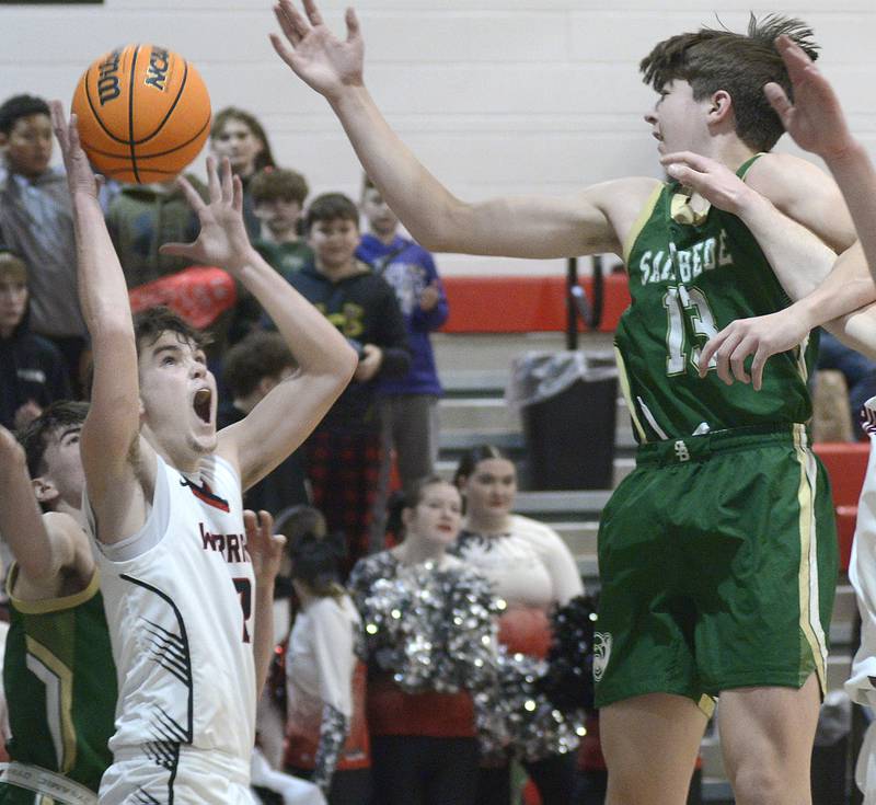 Woodland’s Nolan Price works to get this shot past the block attempt by St Bede’s Graham Ross  in the 2nd quarter Friday at Woodland.