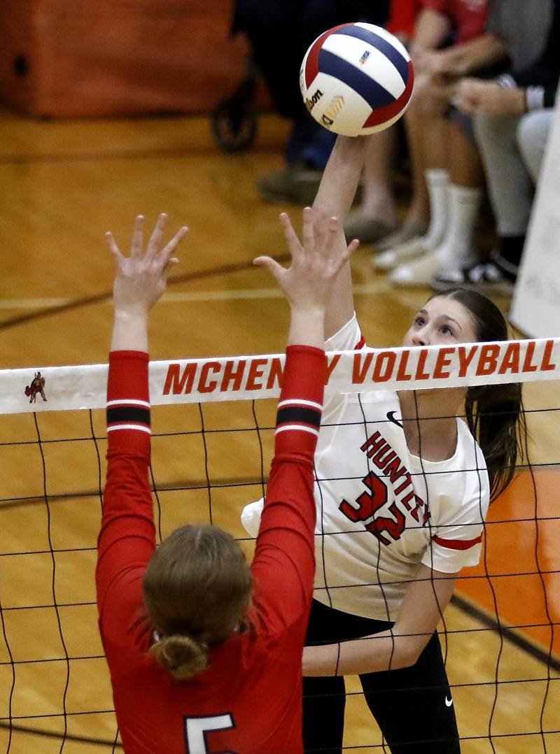 Huntley's Izzy Whitehouse tries to hit the ball over the block of Mundelein's Norah Emso during an IHSA Class 4A McHenry Sectional volleyball match on Tuesday, Nov. 5, 2024, at McHenry High School Freshman Campus.