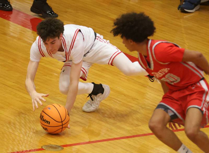 Ottawa's Colt Bryson falls on a loose ball as Streator's Christian Bruton watches during the Class 3A Regional semifinal game on Wednesday, Feb. 25, 2026 in Sellett Gymnasium at L-P High School.