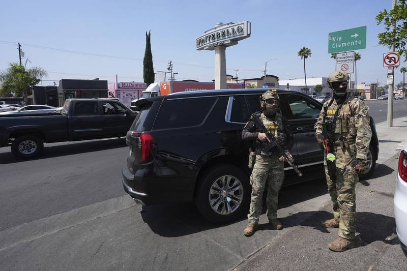 FILE - Immigration agents conduct an operation at a car wash Aug. 15, 2025, in Montebello, Calif. (AP Photo/Gregory Bull, File)