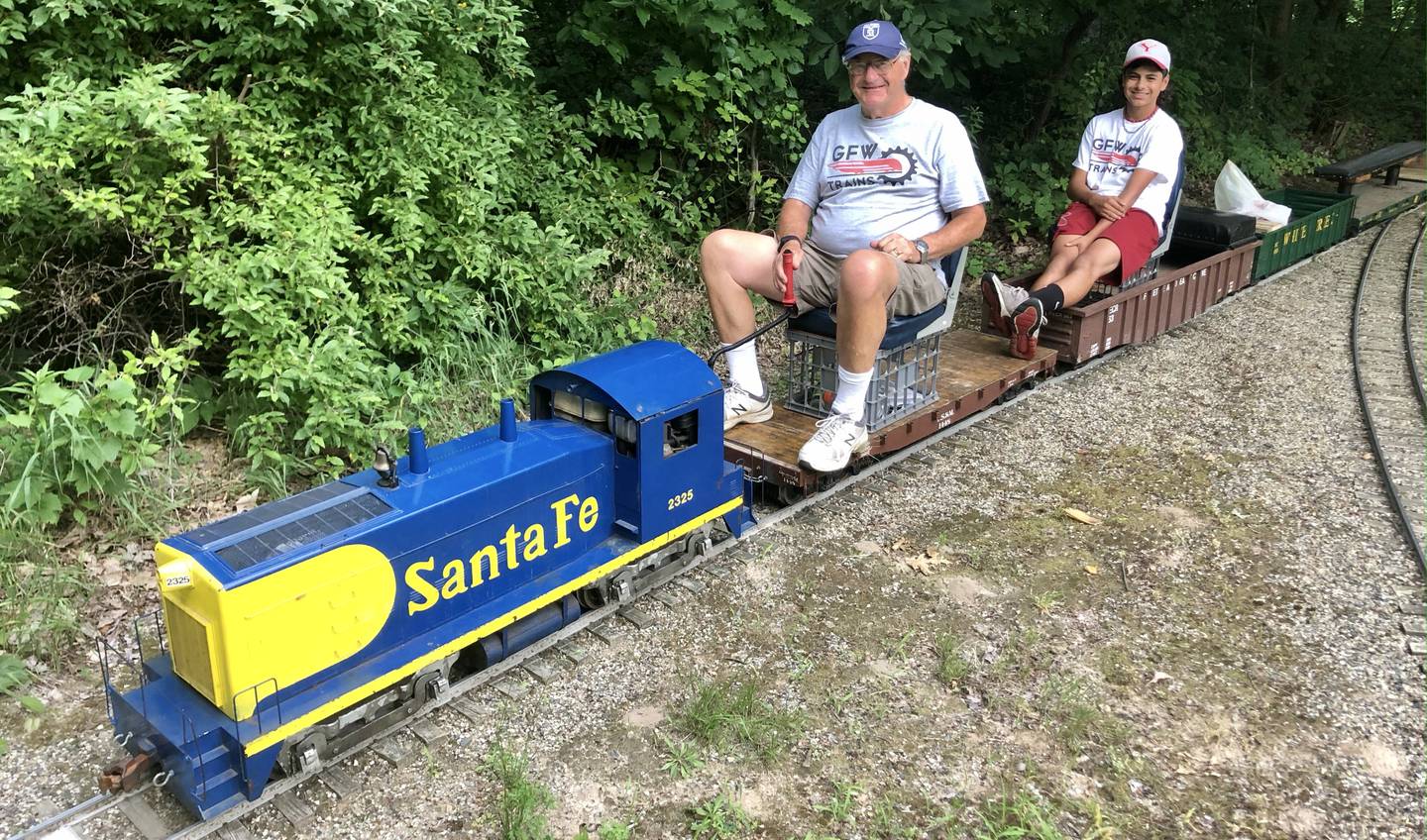 George Werderich and his grandfather George A. Werderich riding their 7.5 gauge train on the Prairie State Railroad in Plowman's Park. (photo provided)