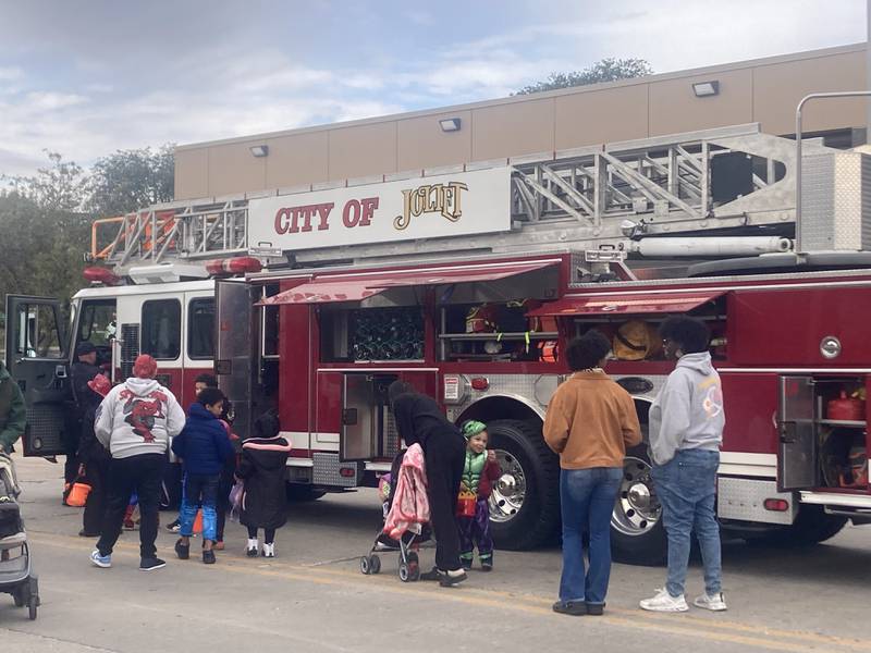 Families gather by a Joliet fire truck at the touch-a-truck area of the Joliet Police Department's trunk-or-treat.
Saturday, Oct. 25, 2025.