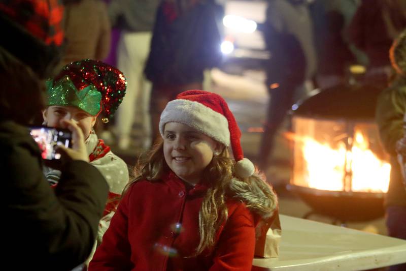 Kendall Kaiser, left, of Huntley poses for pictures with her friend Ellie Wolfe of Marengo as part of holiday events Saturday, Dec. 7, 2024 in downtown Marengo.