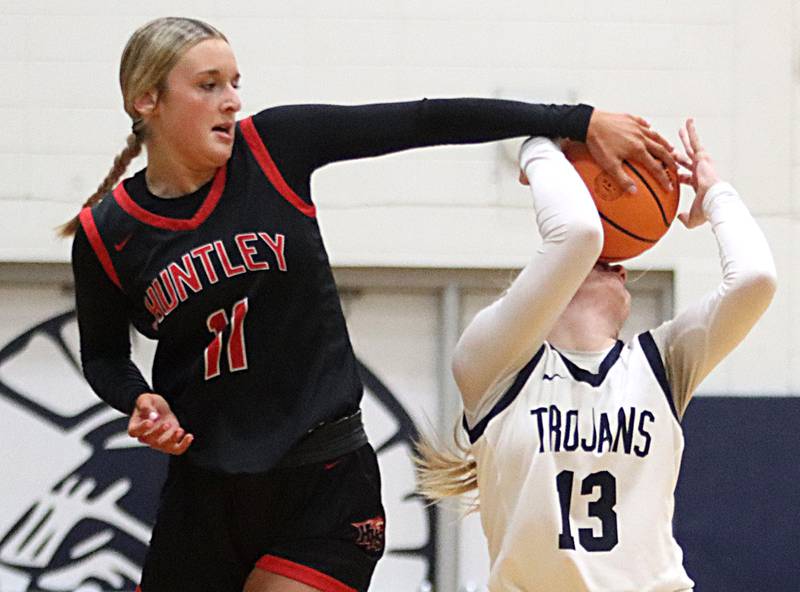 Huntley’s Anna Campanelli, left, stuffs the ball as Cary-Grove’s Malaina Kurth drives past in varsity girls basketball on Friday, Jan. 24, 2025, at Cary-Grove High School in Cary.