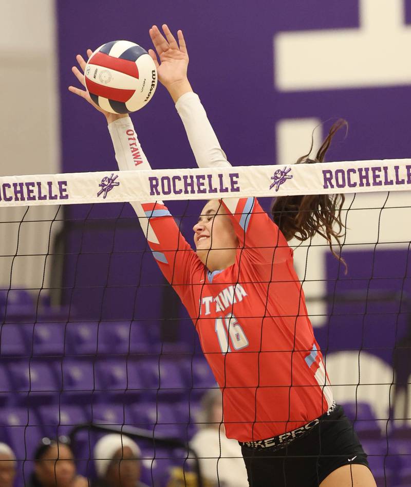 Ottawa's Bella Knoll makes a block against Dixon Tuesday, Oct. 28, 2025, during their Class 3A regional semifinal match at Rochelle High School.