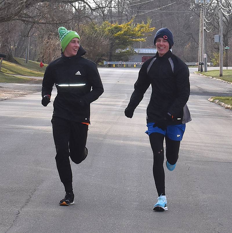 Charles Link (left) and Isaiah McDearmon smile as they run at Morrison's Turkey Trot Saturday, Nov. 30, 2024.