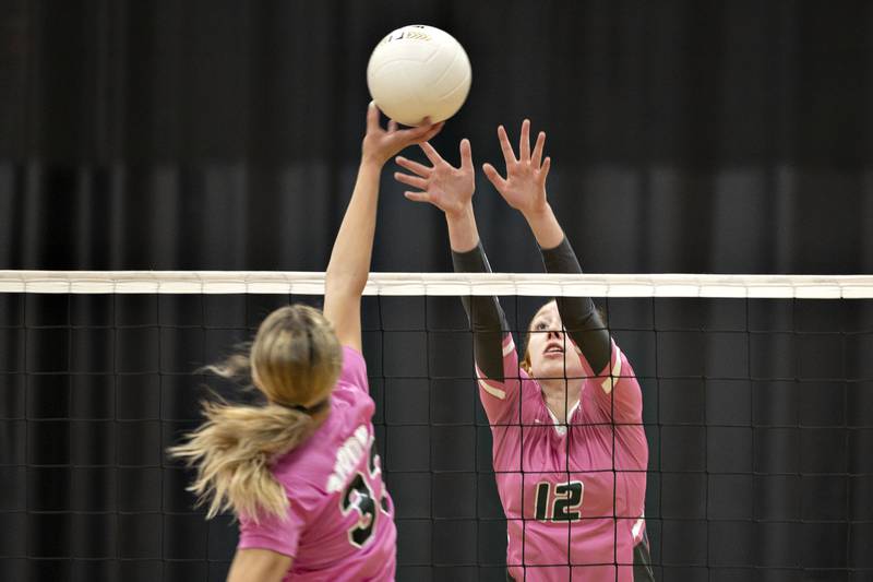 Dixon’s Ella Govig (left) and Rock Falls' Emily Lego work the net Thursday, Oct. 13, 2022.