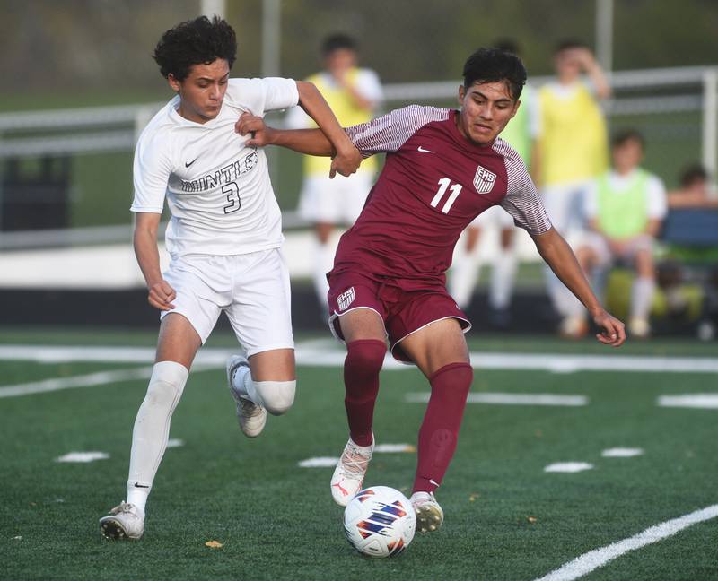 Huntley's Elias Ramon (3) and Elgin's Adan Garcia chase down the ball during Tuesday’s IHSA class 3A sectional semifinal boys soccer game in Round Lake.