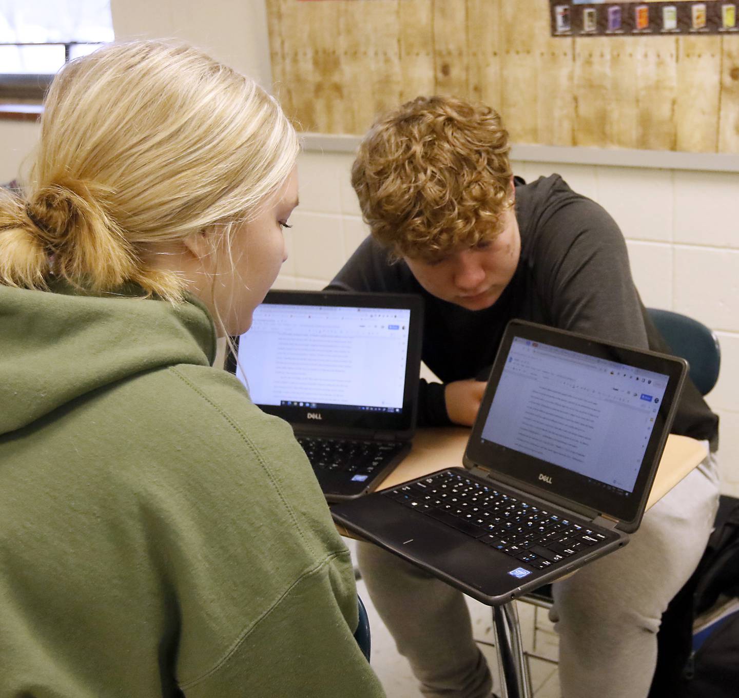 Woodstock High School senior Avery Sternitzky works with fellow senior Hayden Haak during a dual credit composition class on Wednesday, March 1, 2023, at Woodstock High School.