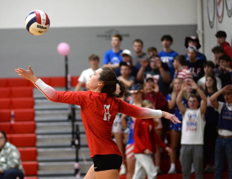 Oregon's Anna Stender (11) serves against Stillman Valley as the Hawks student section cheers during a Big Northern Conference match on Thursday, Oct. 17, 2024 at Stillman Valley.