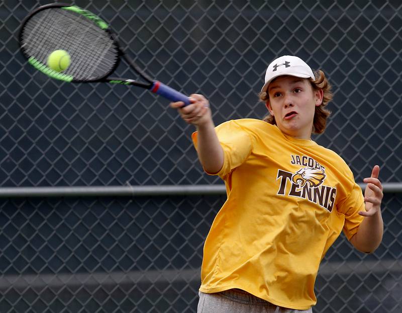 Jacobs’ August Nelson returns the ball during a IHSA 2A boys doubles tennis match Thursday, May 25, 2023, at Buffalo Grove High School.