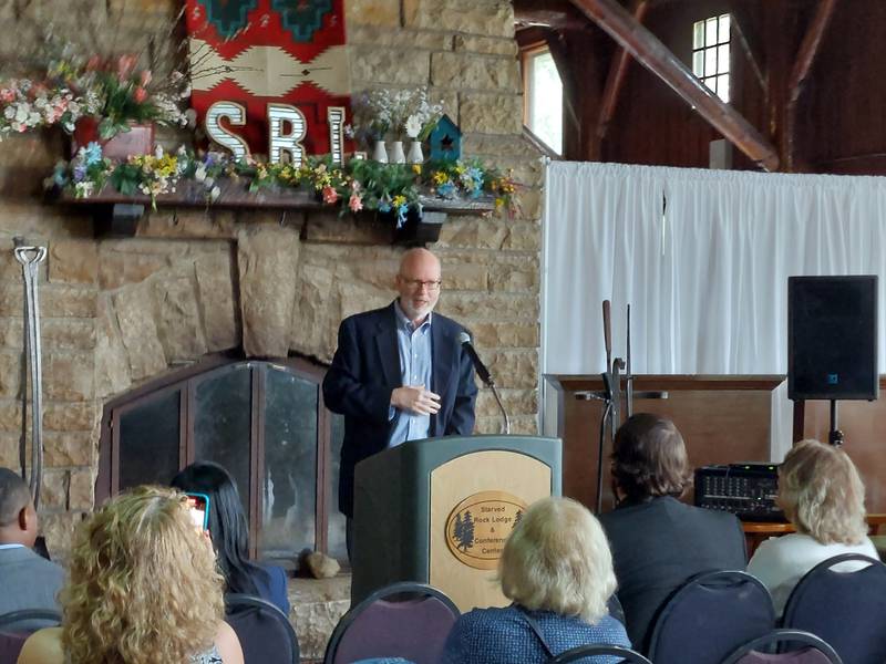 Photographer John Rogner, of Normal, talks about the image he captured of the waterfalls at La Salle Canyon at Starved Rock State Park that is featured on a postage stamp at a ceremony Friday, June 30, 2023, at the Starved Rock Lodge and Conference Center.