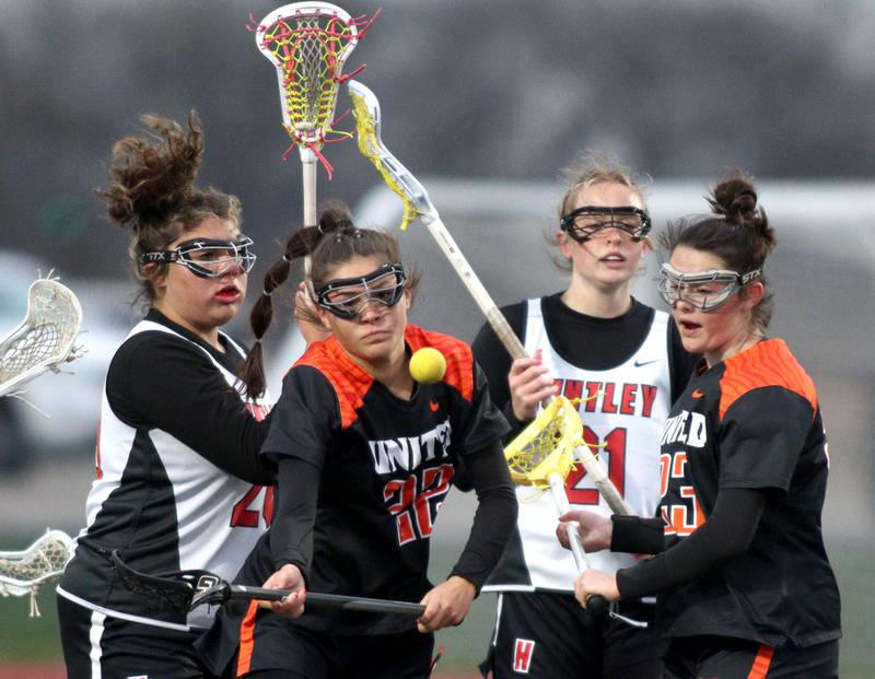 From left, Huntley’s Payton Turczyniak, Crystal Lake Central’s Monica Rueff, Huntley’s Sophie Zion, and Crystal Lake Central’s Colleen Dunlea battle in varsity lacrosse at Huntley Wednesday.